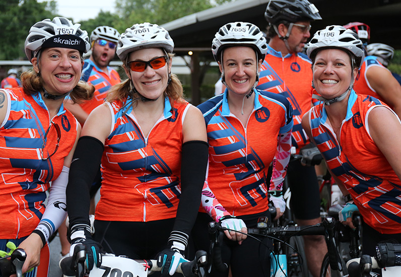 MRE employees pose together on bikes before race