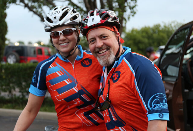 Two MRE employees pose together before bike race